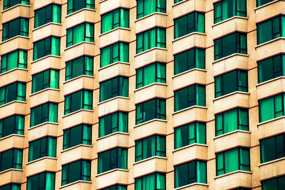 A modern city apartment building with rows of windows