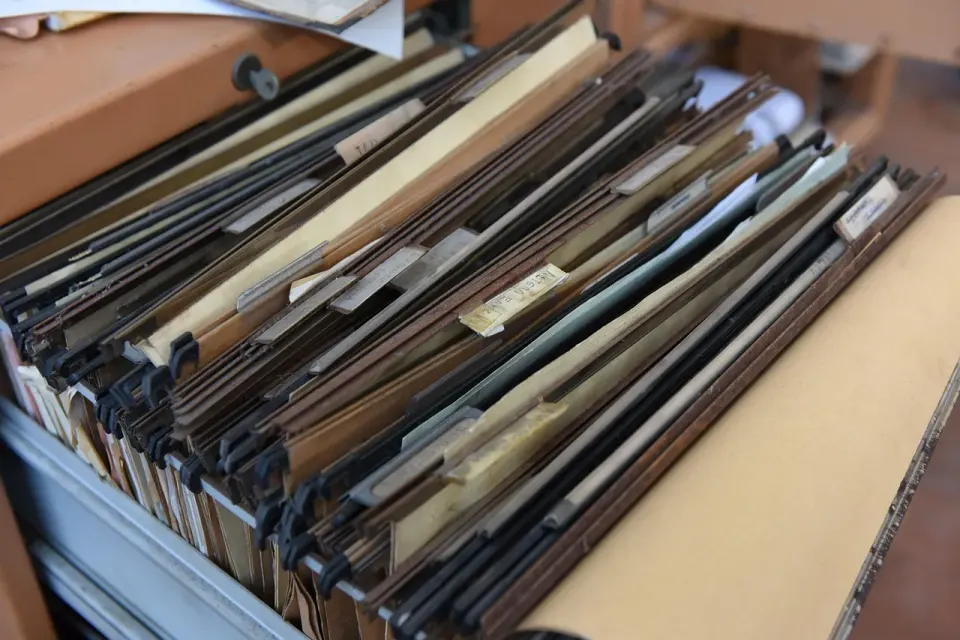 Office document folders stacked on a desk