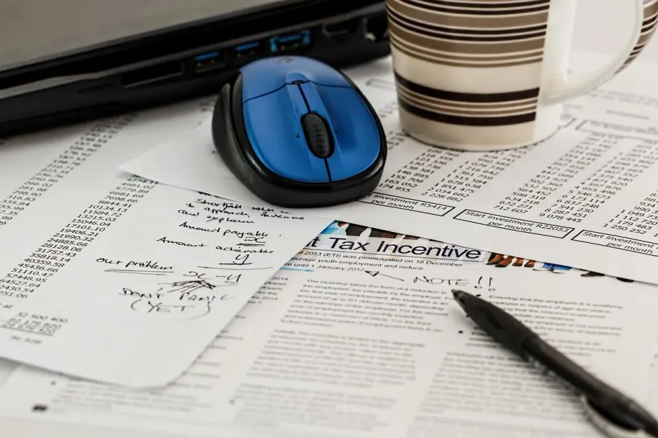Tax forms on a desk next to a calculator