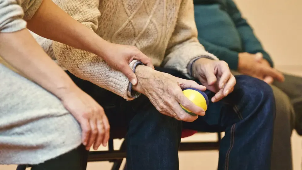 Older adults exercising with a ball during a therapy session